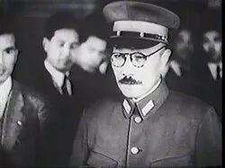 Hideki Tōjō in divisa e berretto militare, tra alcuni uomini in abito civile